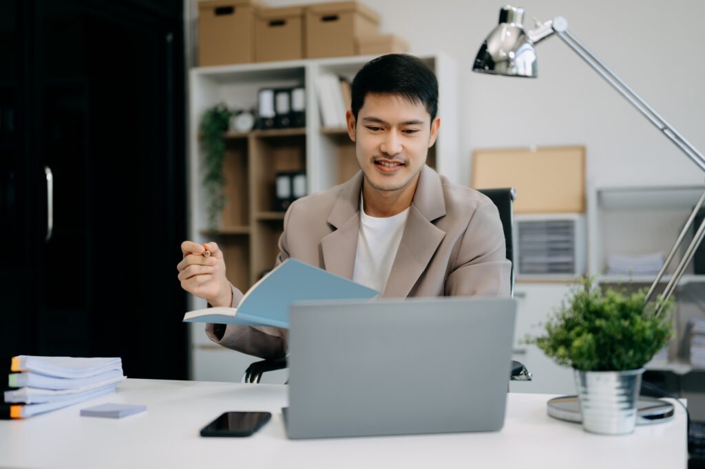 business man executive manager looking at laptop watching online webinar training